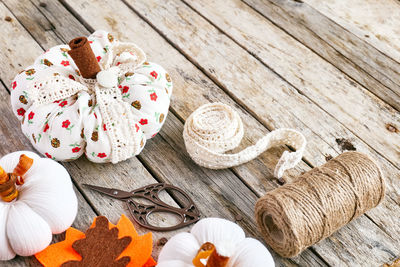 Autumn decoration with handmade fabric pumpkins on wooden background. fall vibes. thanksgiving decor
