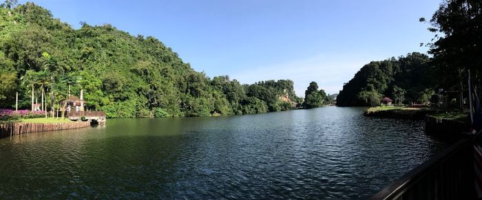 Scenic view of river against clear blue sky