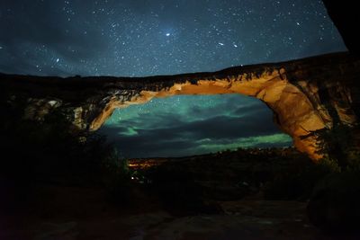 Scenic view of illuminated mountains against sky at night