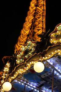 Low angle view of illuminated christmas lights at night