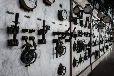 Machine valves and gauge on wall in factory