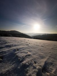 Scenic view of snowcapped mountains against sky during winter