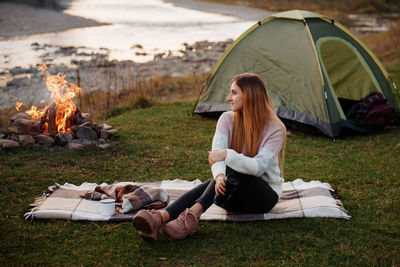 Portrait of young woman sitting in tent