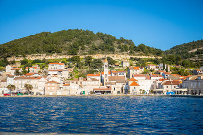 Town by sea against sky