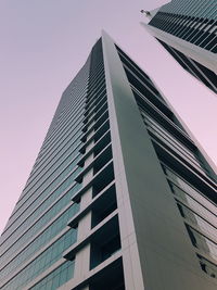 Low angle view of office building against clear sky