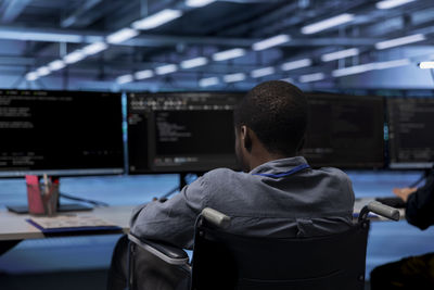 Rear view of man standing in factory