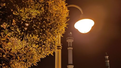 A yellow light that illuminates the surrounding streets from the dark night