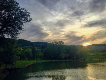 Scenic view of lake against sky during sunset