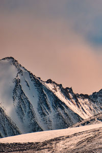 Scenic view of snowcapped mountains against sky during sunset