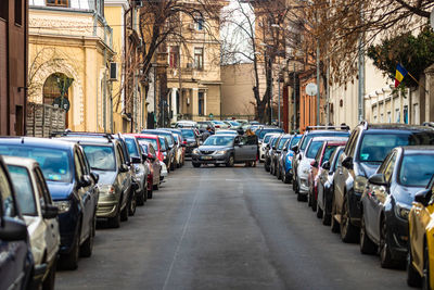 Cars on street amidst buildings in city