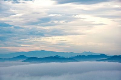 Scenic view of mountains against cloudy sky