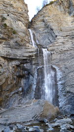 Scenic view of waterfall against sky