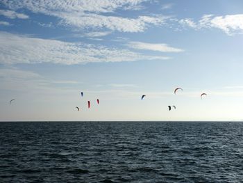 Low angle view of kiteboard over sea against sky