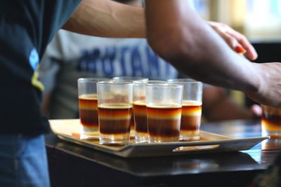 Close-up of cropped hand holding coffee
