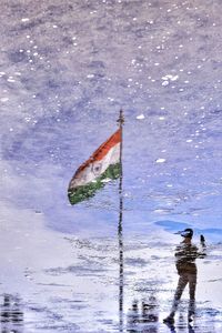 Reflection of man in fish tank