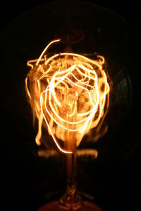 Close-up of fire in dark room