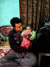 Mother and daughter sitting on floor