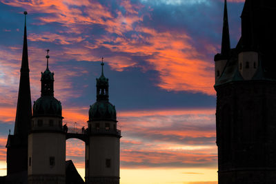 Low angle view of building against cloudy sky during sunset