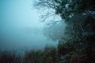 Scenic view of lake in foggy weather