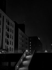Low angle view of illuminated buildings against sky at night
