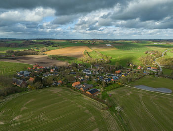 High angle view of people walking on field against sky