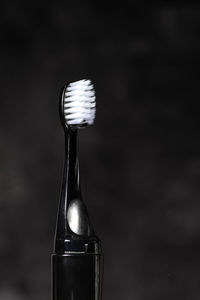 Modern rechargeable sonic or electric black toothbrush with copy space