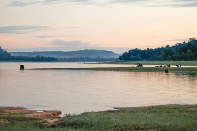 Scenic view of lake against sky during sunset