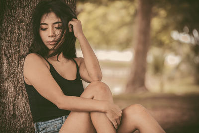 Midsection of woman sitting outdoors