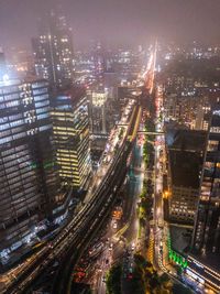 High angle view of illuminated city buildings at night