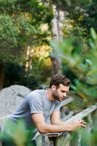 Side view of man sitting on field