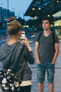 Rear view of men standing in city
