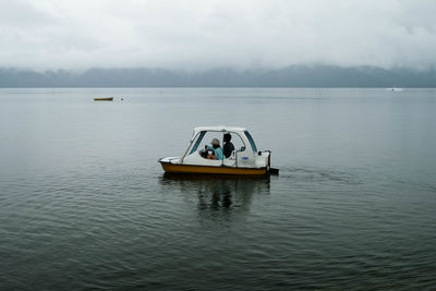 Boat sailing in sea against sky