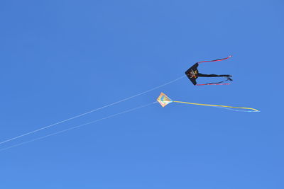 Low angle view of airshow against clear blue sky