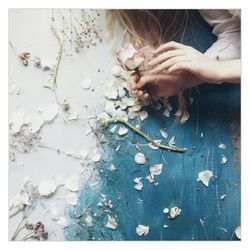 Cropped image of woman holding flower