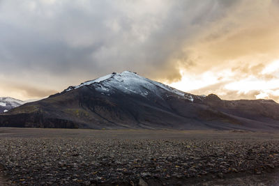 Scenic view of mountains against cloudy sky