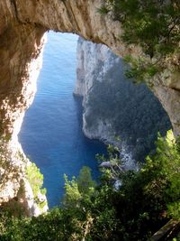 High angle view of rock formation amidst sea