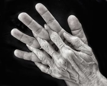 Close-up of hands over black background