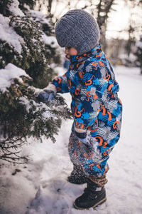 Rear view of boy standing on snow