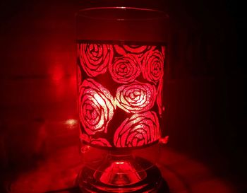 Close-up of illuminated lamp on table