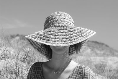 Young woman wearing hat on the beach