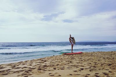 Full length of woman on beach against sky