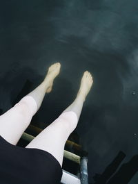 Low section of woman legs in water