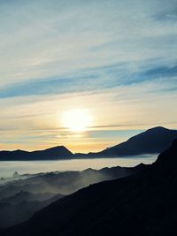 Scenic view of silhouette mountains against sky during sunset