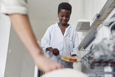 Boy cleaning up after meal