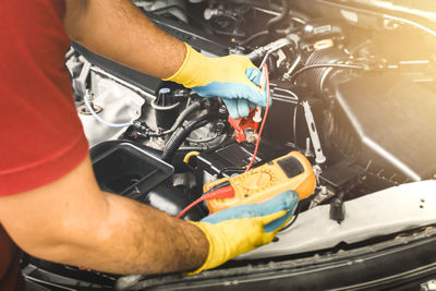 Close-up of man working in car