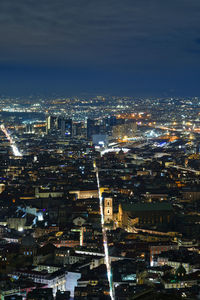 High angle view of illuminated cityscape against sky at night