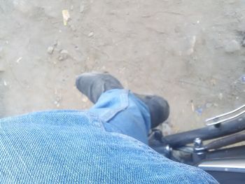 Low section of man wearing shoes