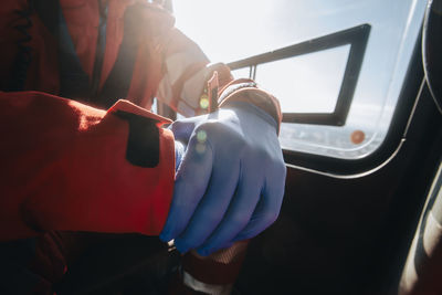 Close-up hands of prepared doctor in surgical gloves inside helicopter of emergency medical service. 