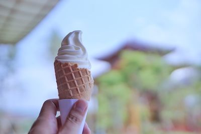 Hand holding ice cream cone