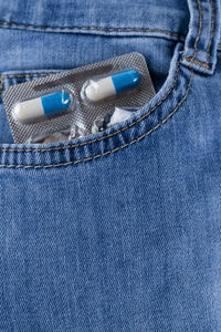 Close-up of blister pack in jeans pocket